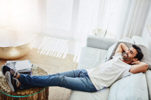 man relaxing on sofa at home