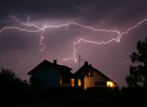 lightning storm over well-lit home