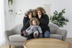 Family bundled up on couch